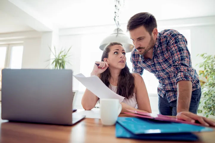 A couple discussing joint tenancy on a deed.