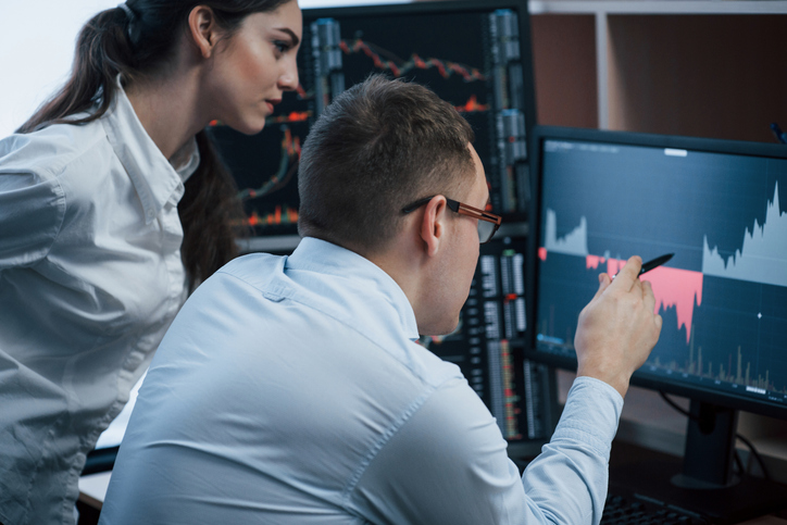 Financial advisors reviewing the performance of an investment portfolio.