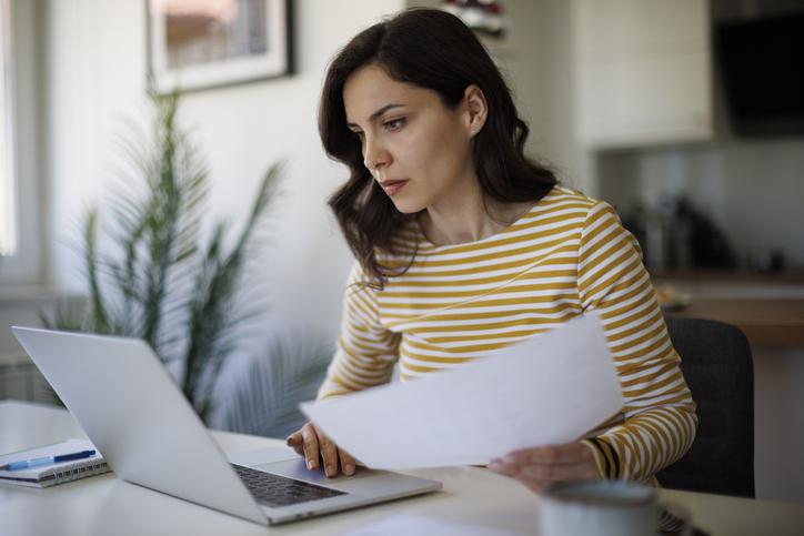 A woman reviewing a gift letter for her mortgage application. 