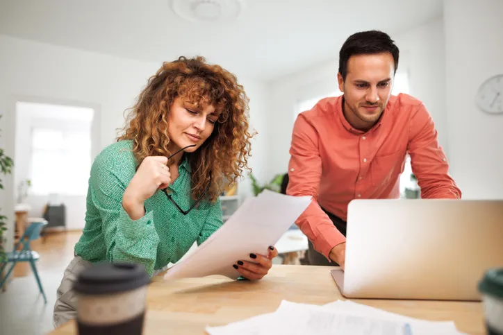 A couple reviewing the title of a property.