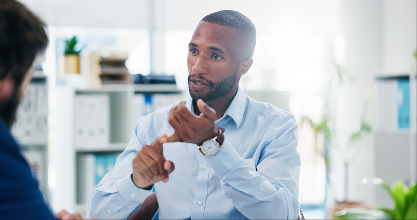 A man speaks during a client consultation. 