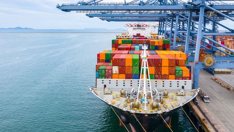 A cargo ship docked at a terminal.