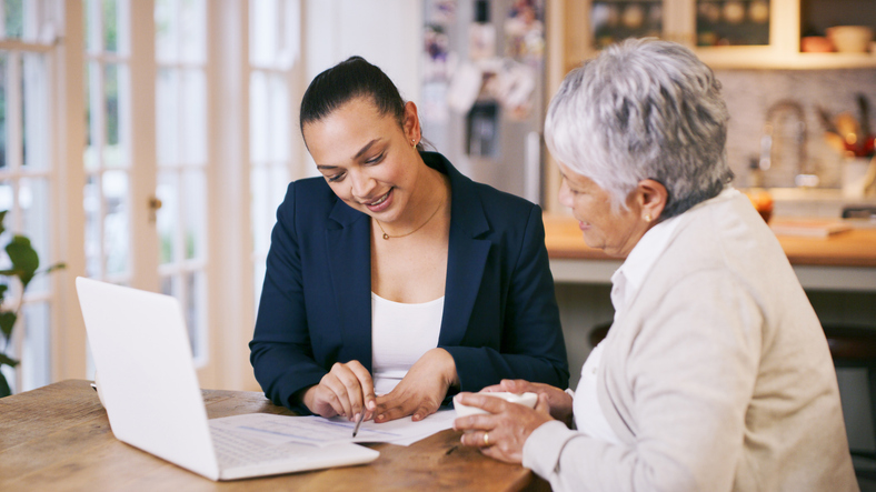 A senior reviewing her retirement plan with a financial advisor. 