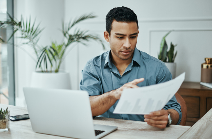 An investor reviewing documents for his portfolio.