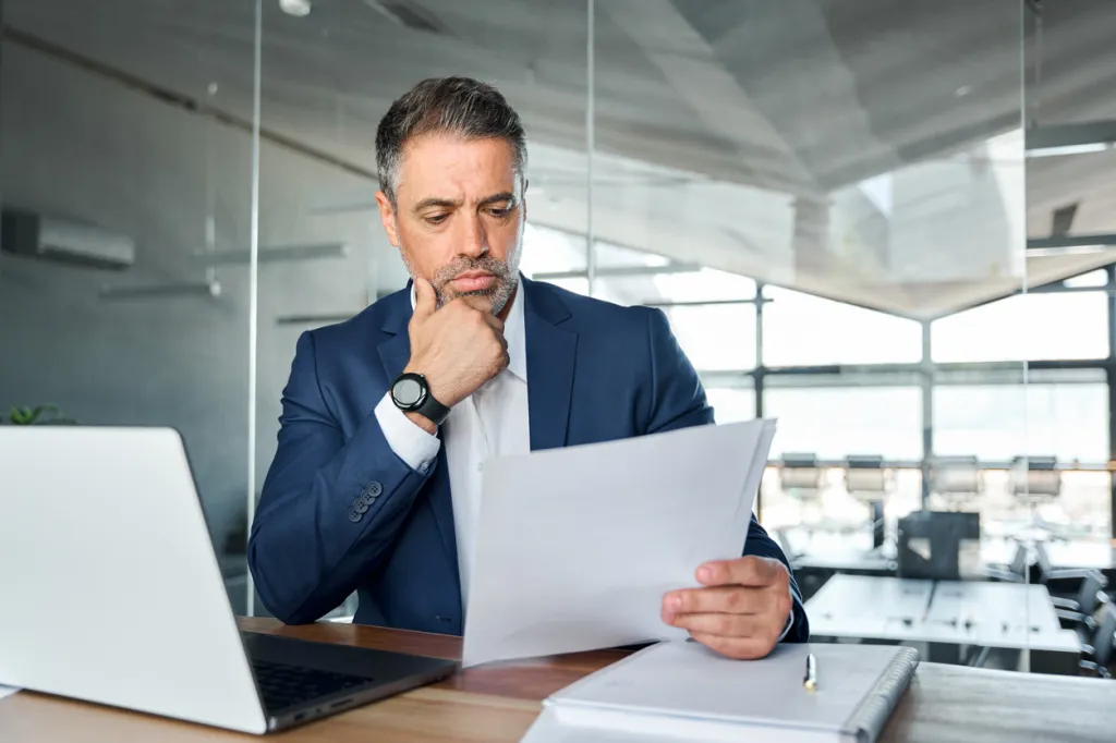 A financial advisor reviewing documentation for a client.