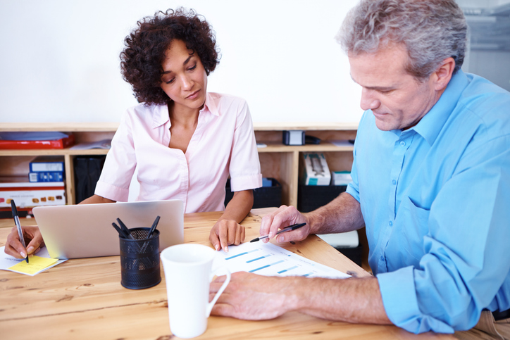 Real estate investors reviewing a portfolio.