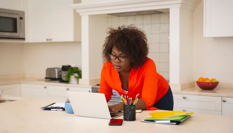 A woman reviewing her retirement plan to make adjustments for her goals.