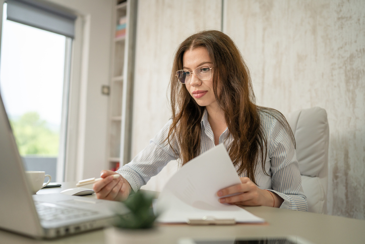 A woman reviewing government legislation that could impose tariffs.