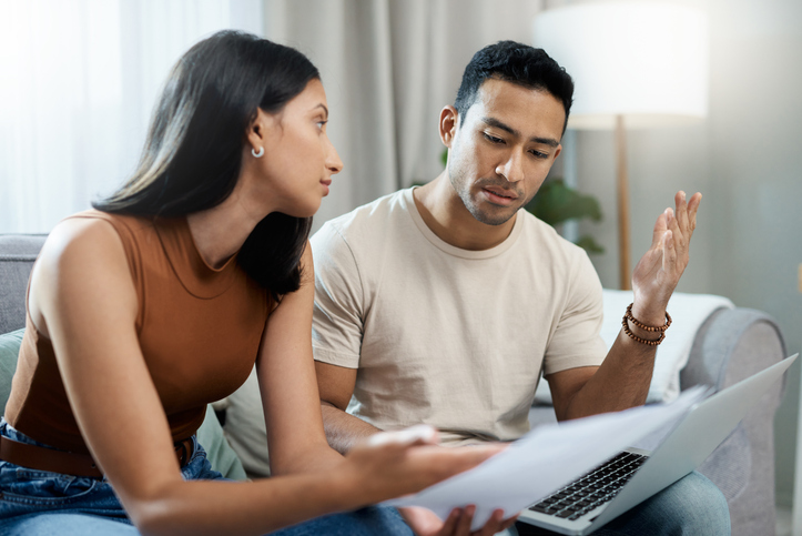 A divorced couple discussing debt repayment strategies.