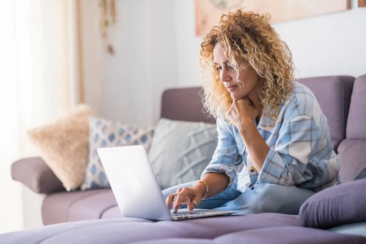 A woman researches different types of bank transfers.