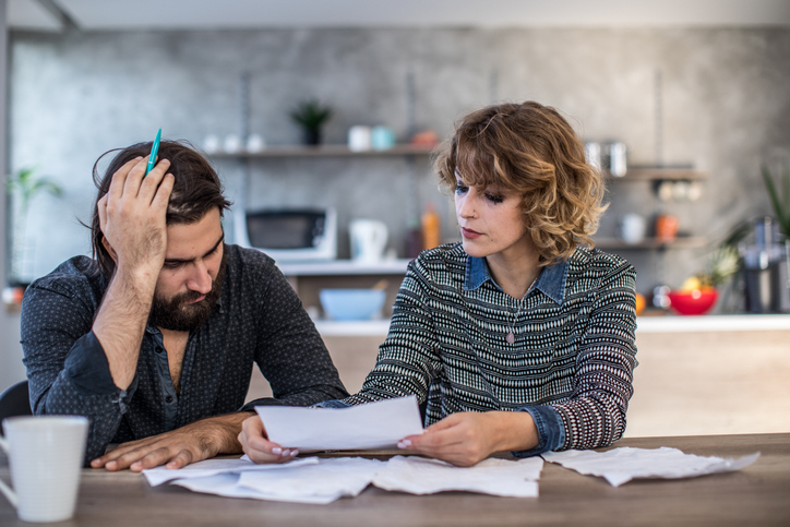 A couple reviewing their marital debt and overall finances. 