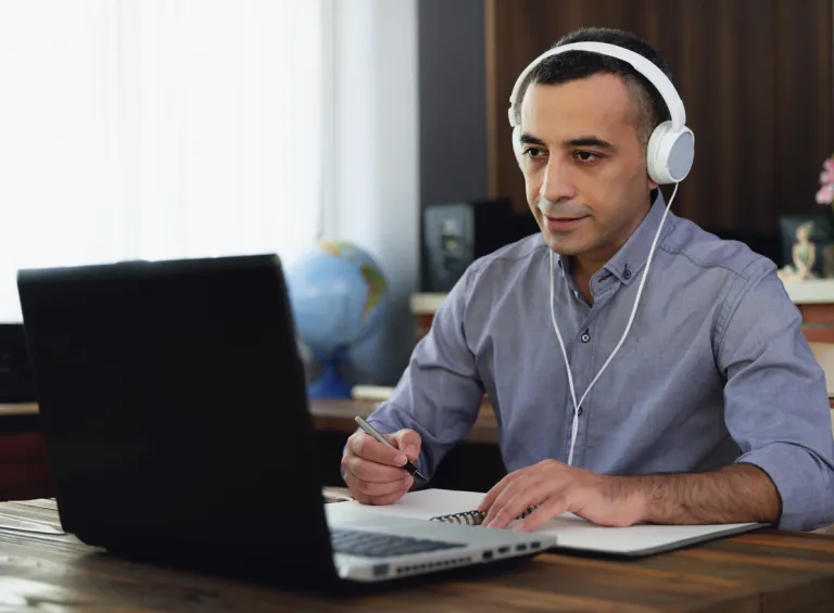 An investor discussing his investment portfolio via video with an advisor.