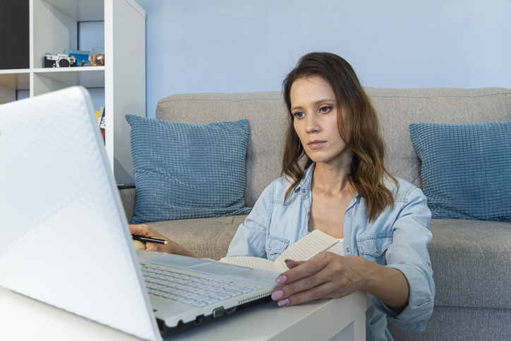 A woman reviewing her retirement accounts at home.