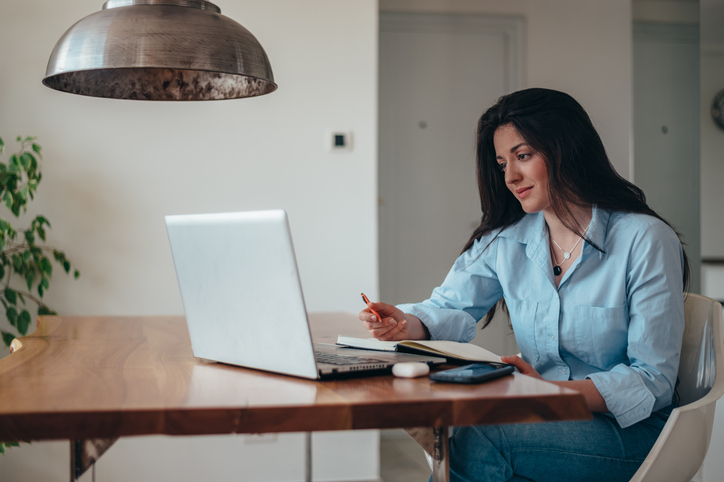 A woman researching how to consolidate her retirement accounts.