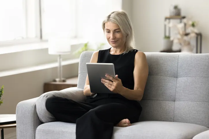 A real estate investor reviews her portfolio at home.