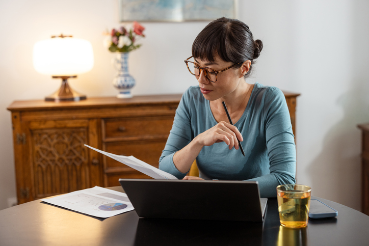 An investor reading documents for her portfolio.