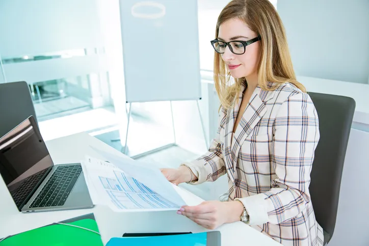 An investor reviews documents for her portfolio.