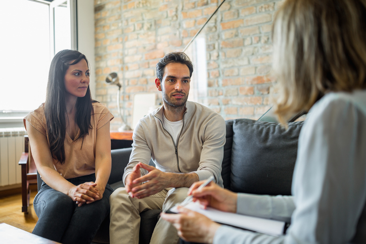 A couple discussing their finances with a financial advisor.