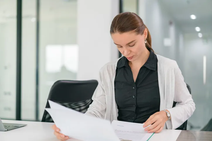 A woman reviewing tax documents.