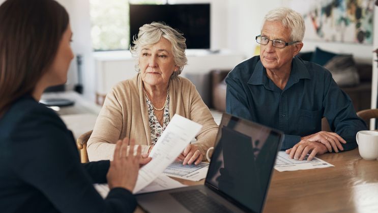 A senior couple meets with a financial advisor.