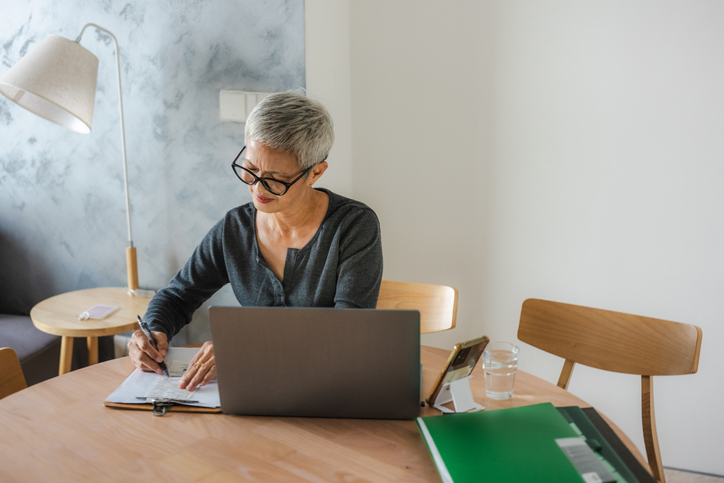 A woman reviewing steps to calculate the alternative minimum tax (AMT).