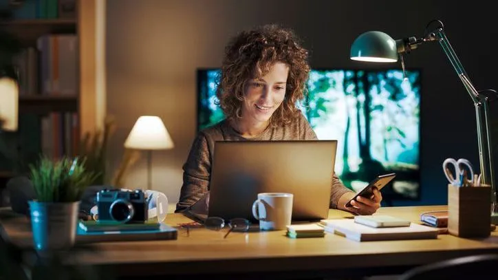 A woman sitting at the desk in her home office.