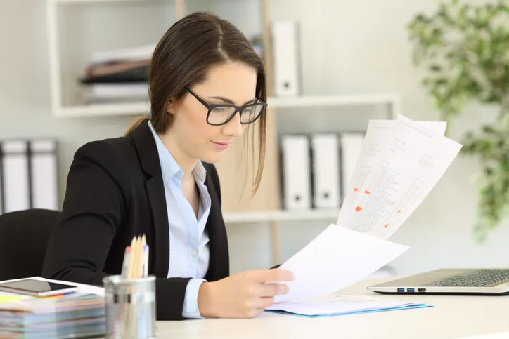 An investor reviewing documents for her real estate portfolio.