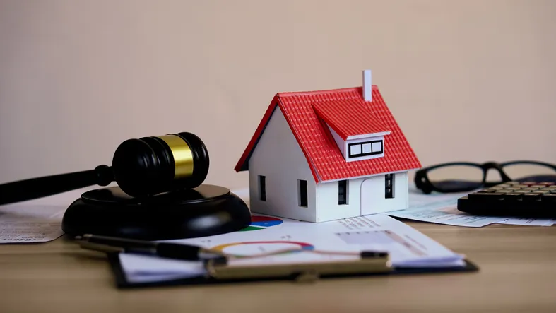 A model house and gavel.
