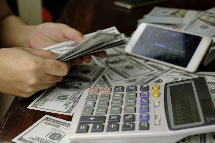 A businessperson counting money.