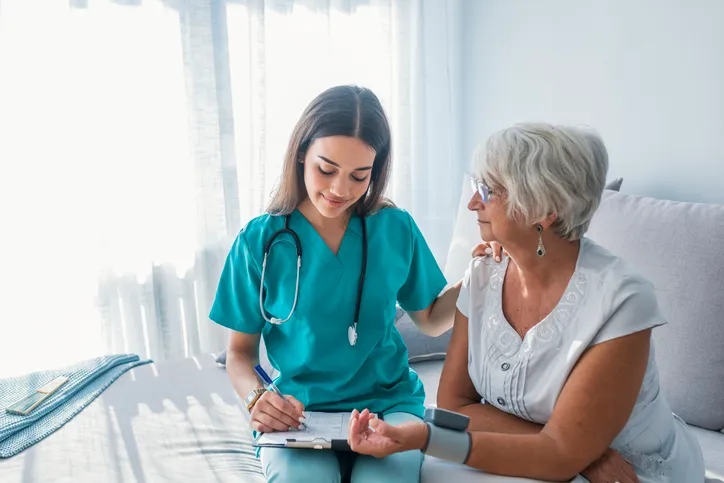 Nurse doing blood pressure monitoring.