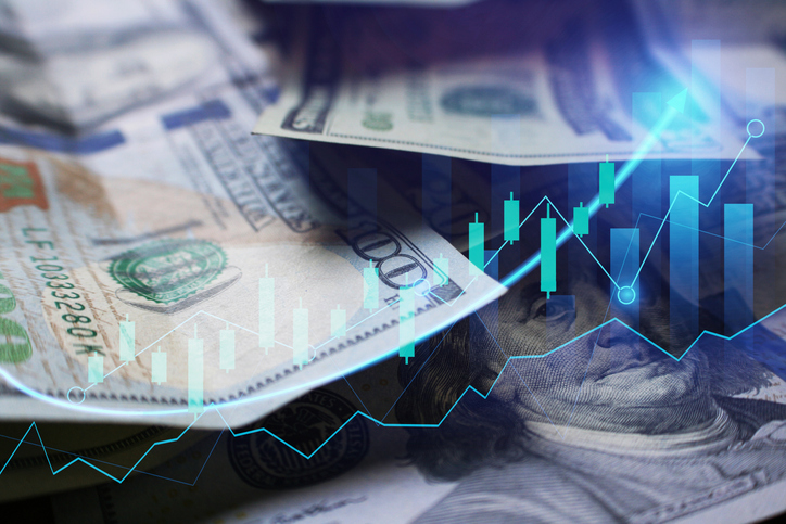 $100 bills overlaid with a stock chart.