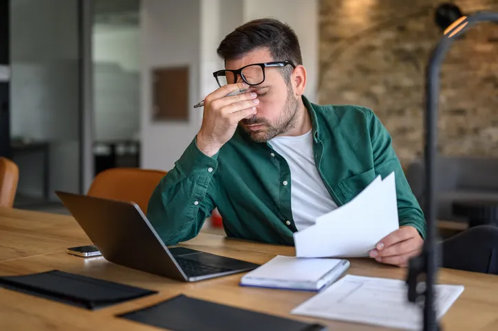 Anxious man doing his finances.