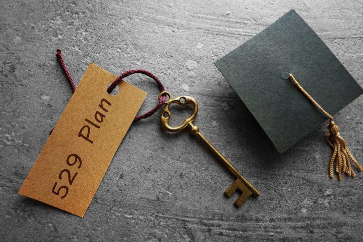 Gold key with 529 plan tag and graduation cap.