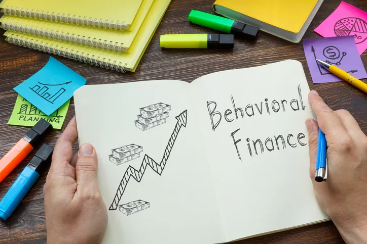 A notebook with "behavioral finance" written on the page.