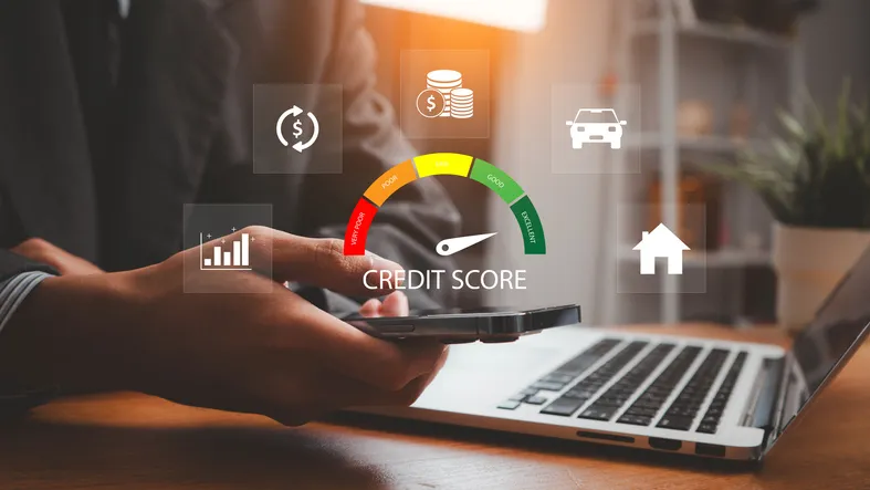 A man on a computer, with the credit score icon.
