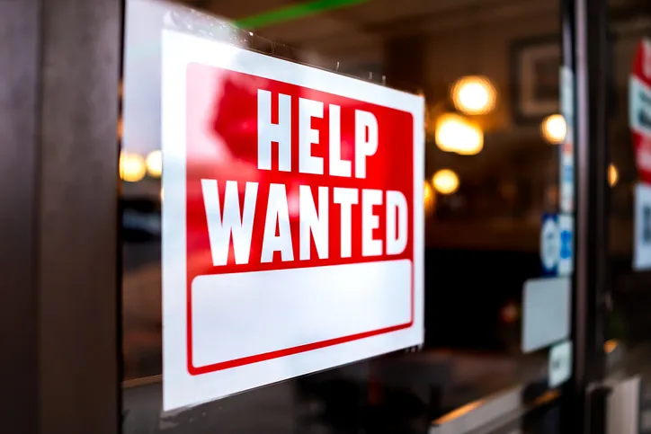 Sign text Closeup of a "Help Wanted" sign.
