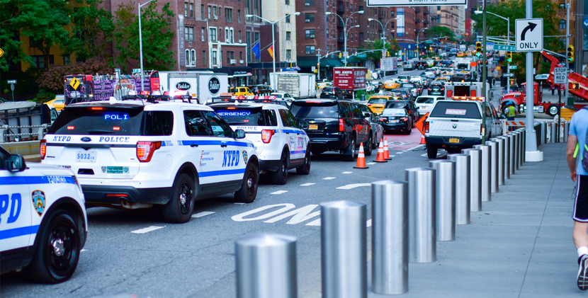 Traffic jam in New York City including NYPD SUVs.