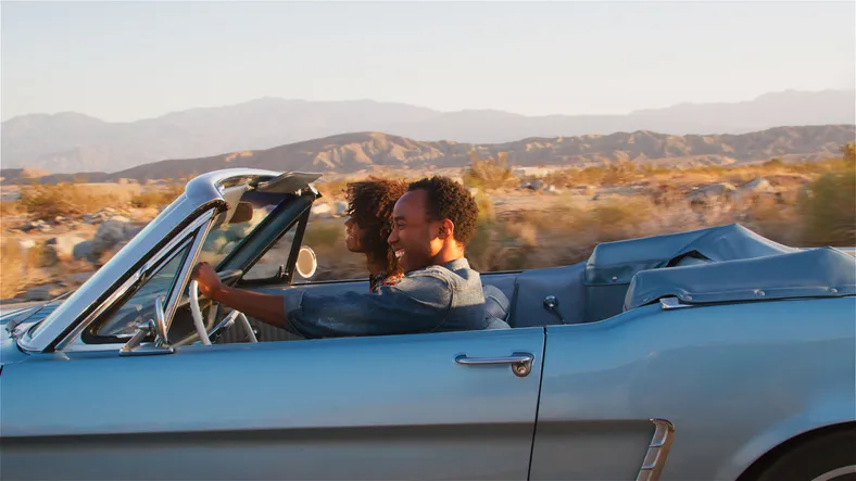 Young couple in a convertible.