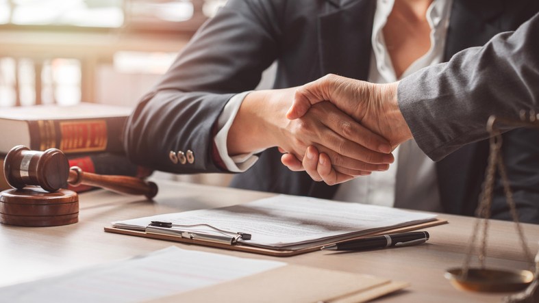 Tax planner and client shaking hands.