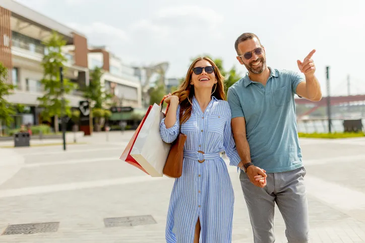 Couple walks hand in hand.
