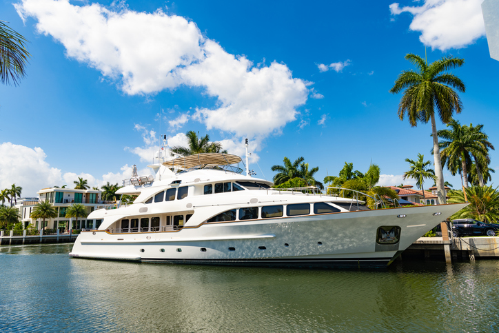 Harbor with yacht at seaside summer destination.