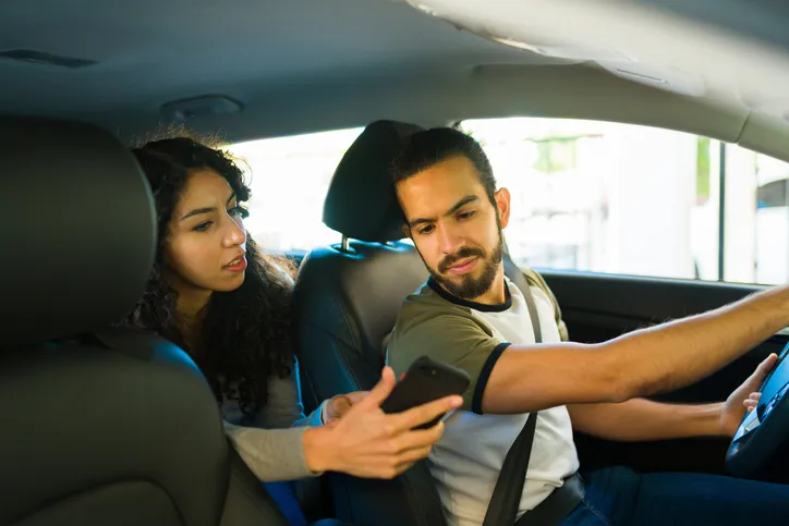 Passenger giving directions to the driver.
